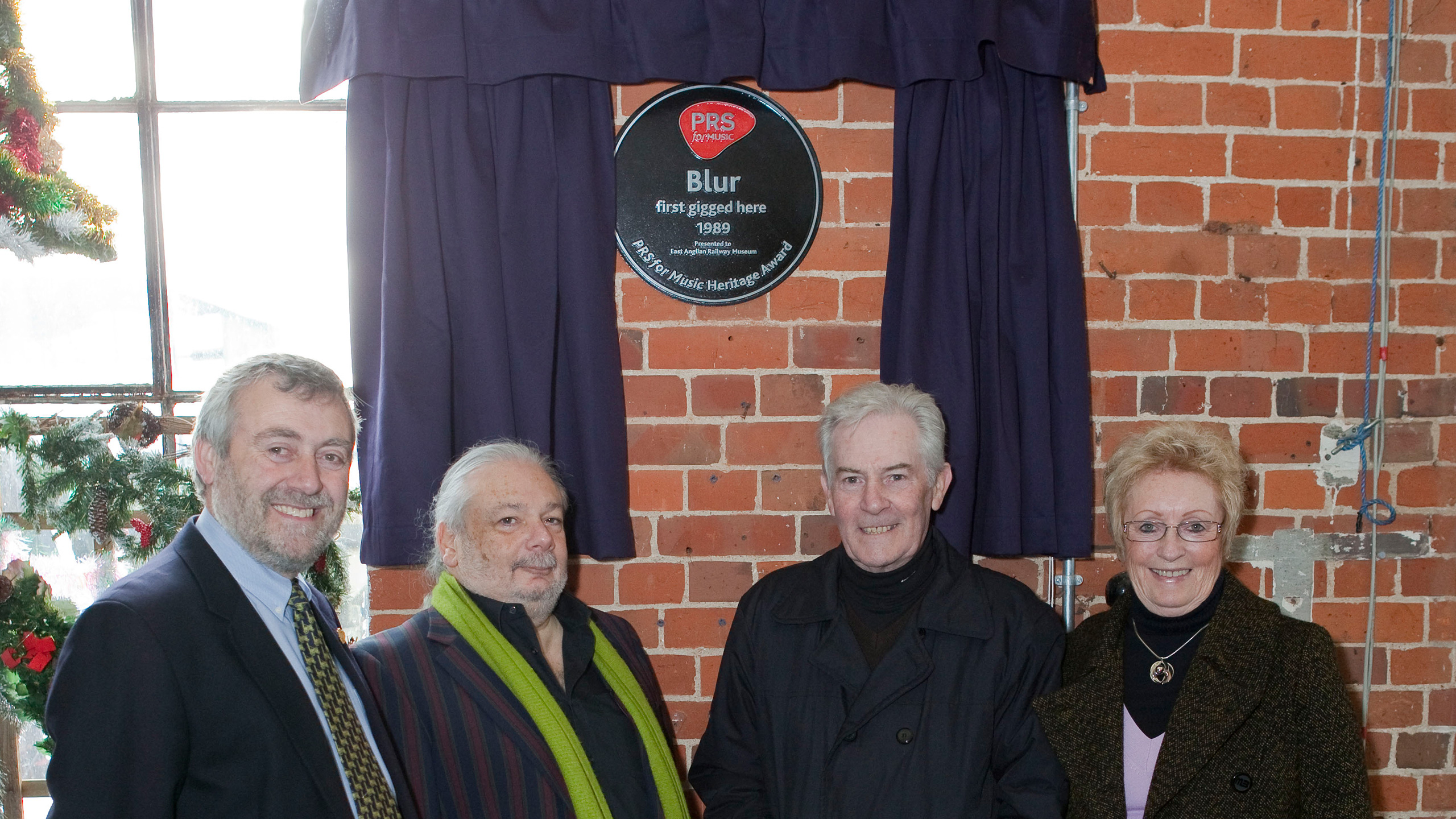 Staff from Good Sheds at East Anglian Railway Museum with their Heritage Award plaque