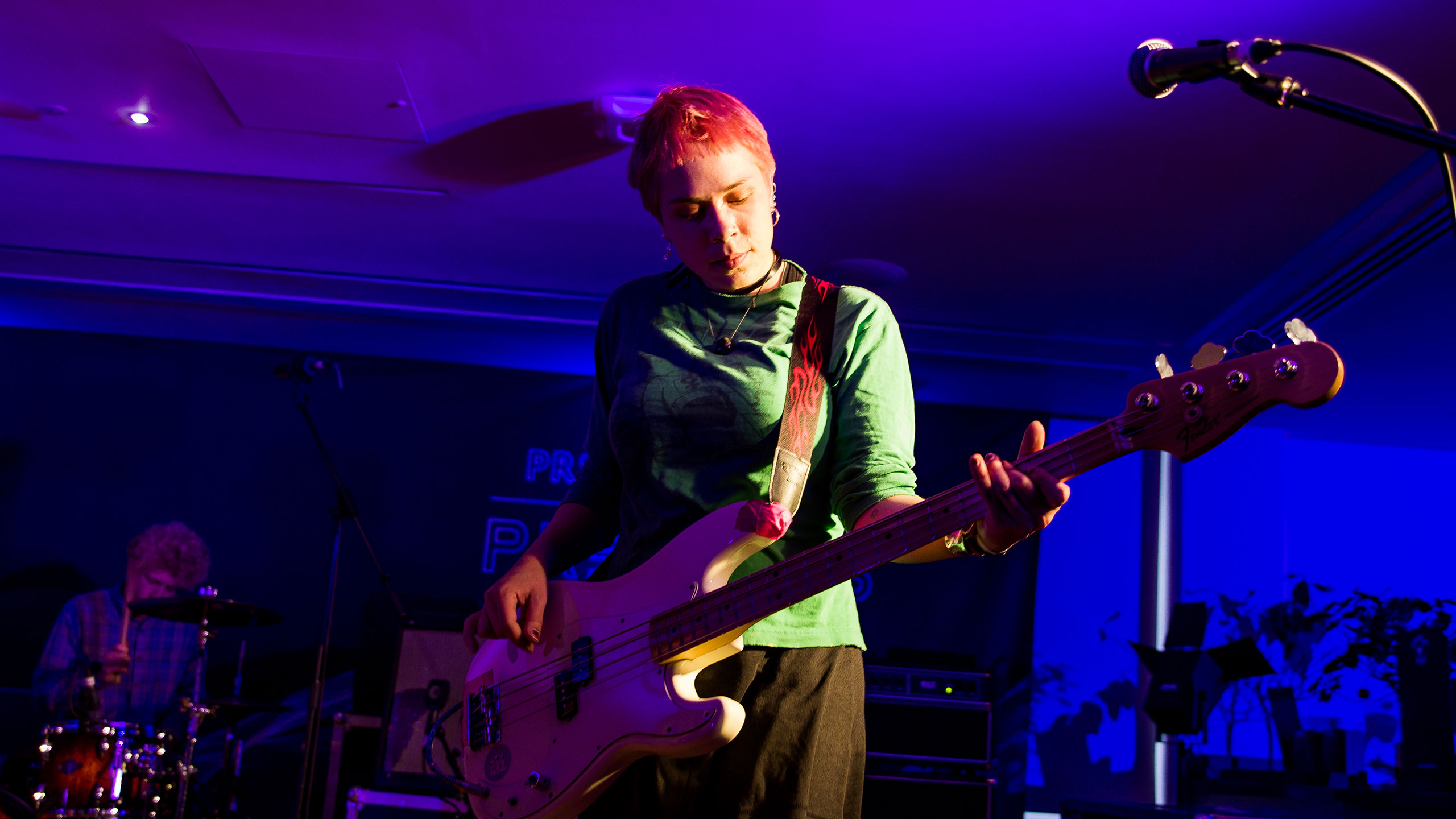 Dream Wife's Bella Podpadek plays bass on stage at PRS for Music Presents, wearing a green top