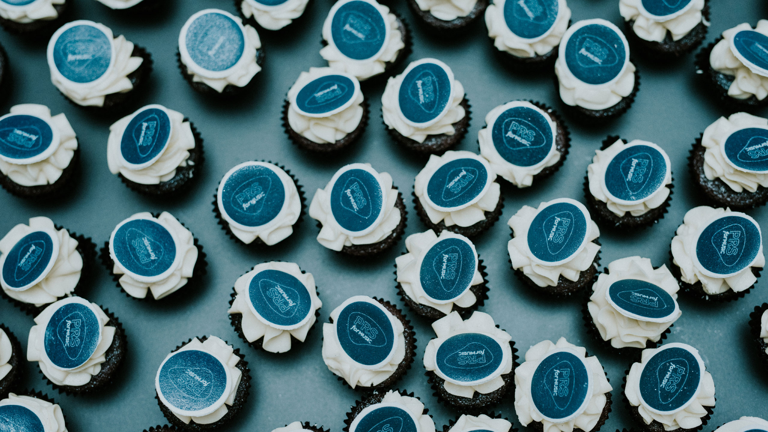 Blue and white cupcakes on a blue table