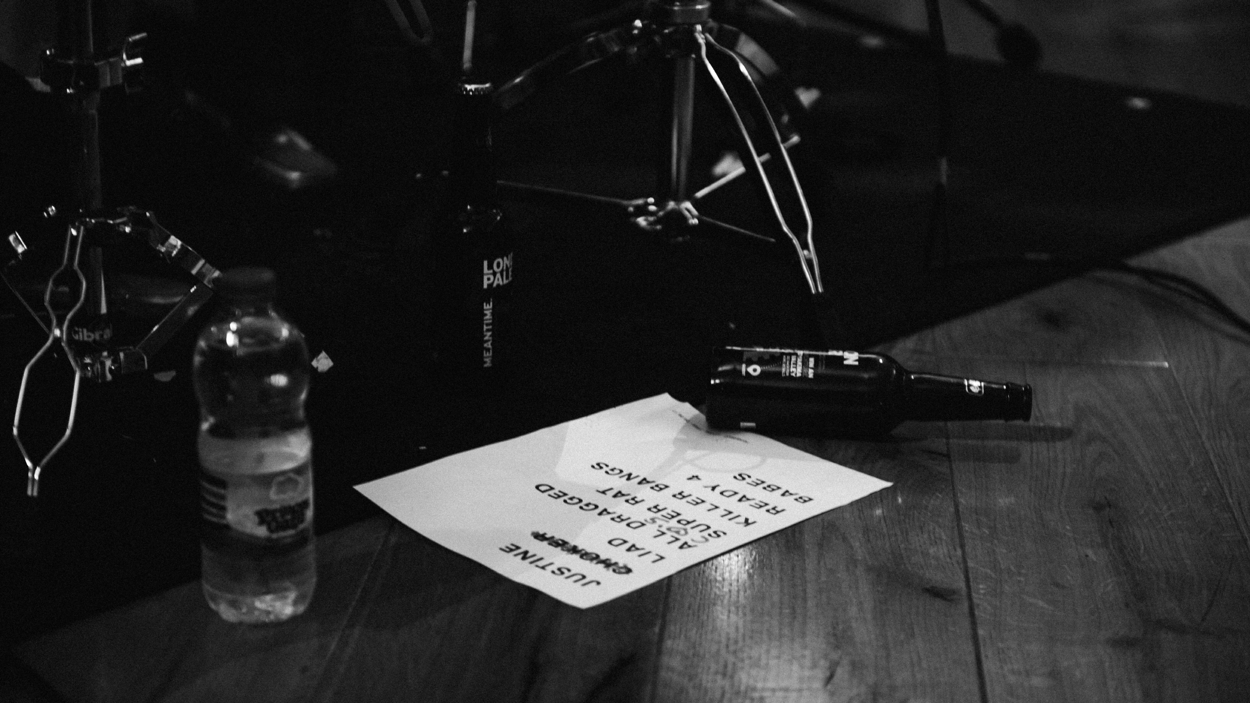 A set list and two bottles on a stage