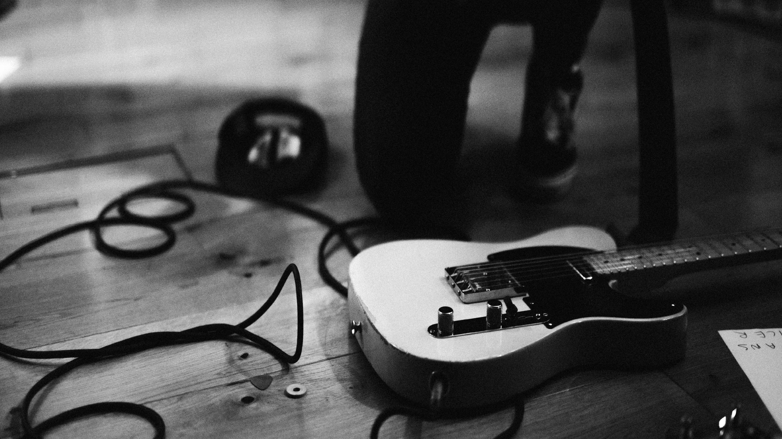 A guitar on the floor with cables