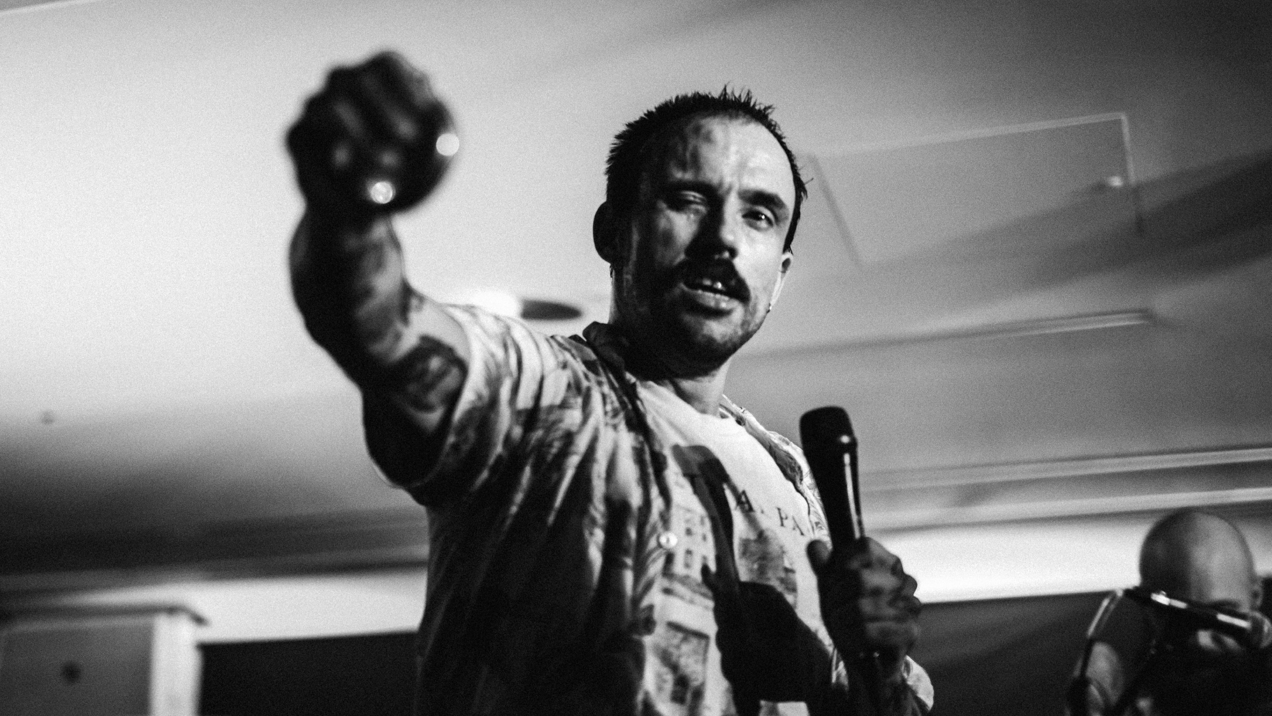Idles frontman Joe Talbot punching his fist on stage at PRS for Music Presents