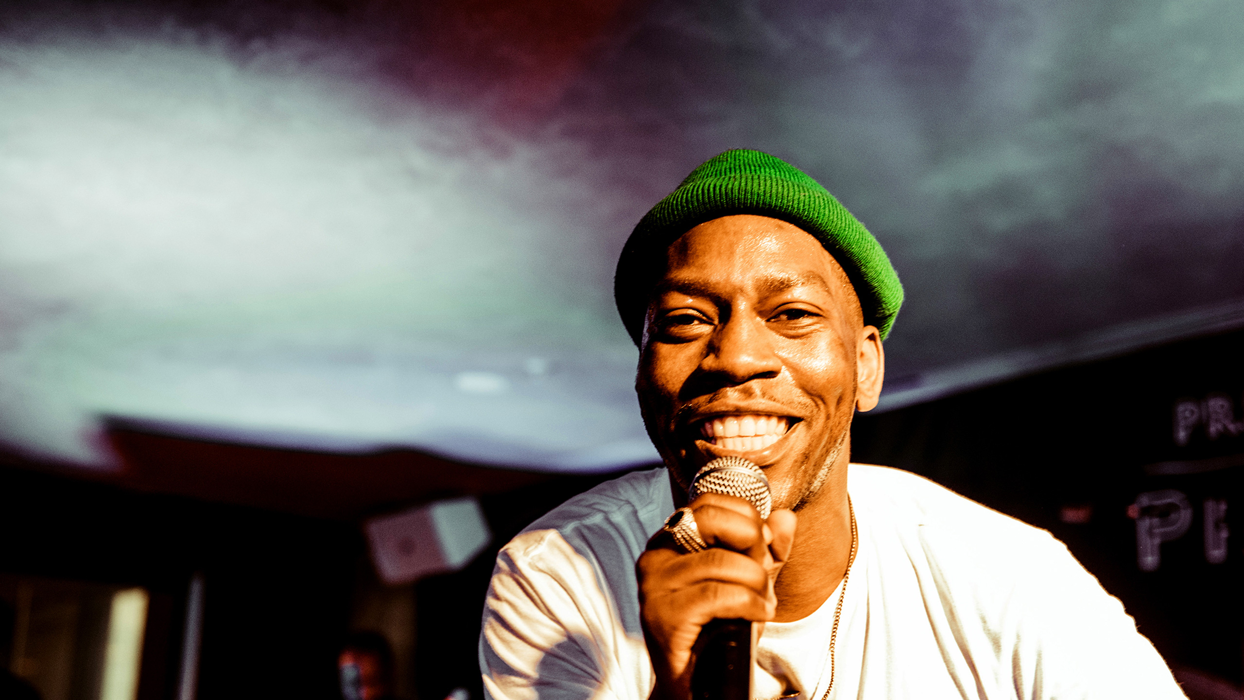 Tiggs Da Author performing and smiling at the camera