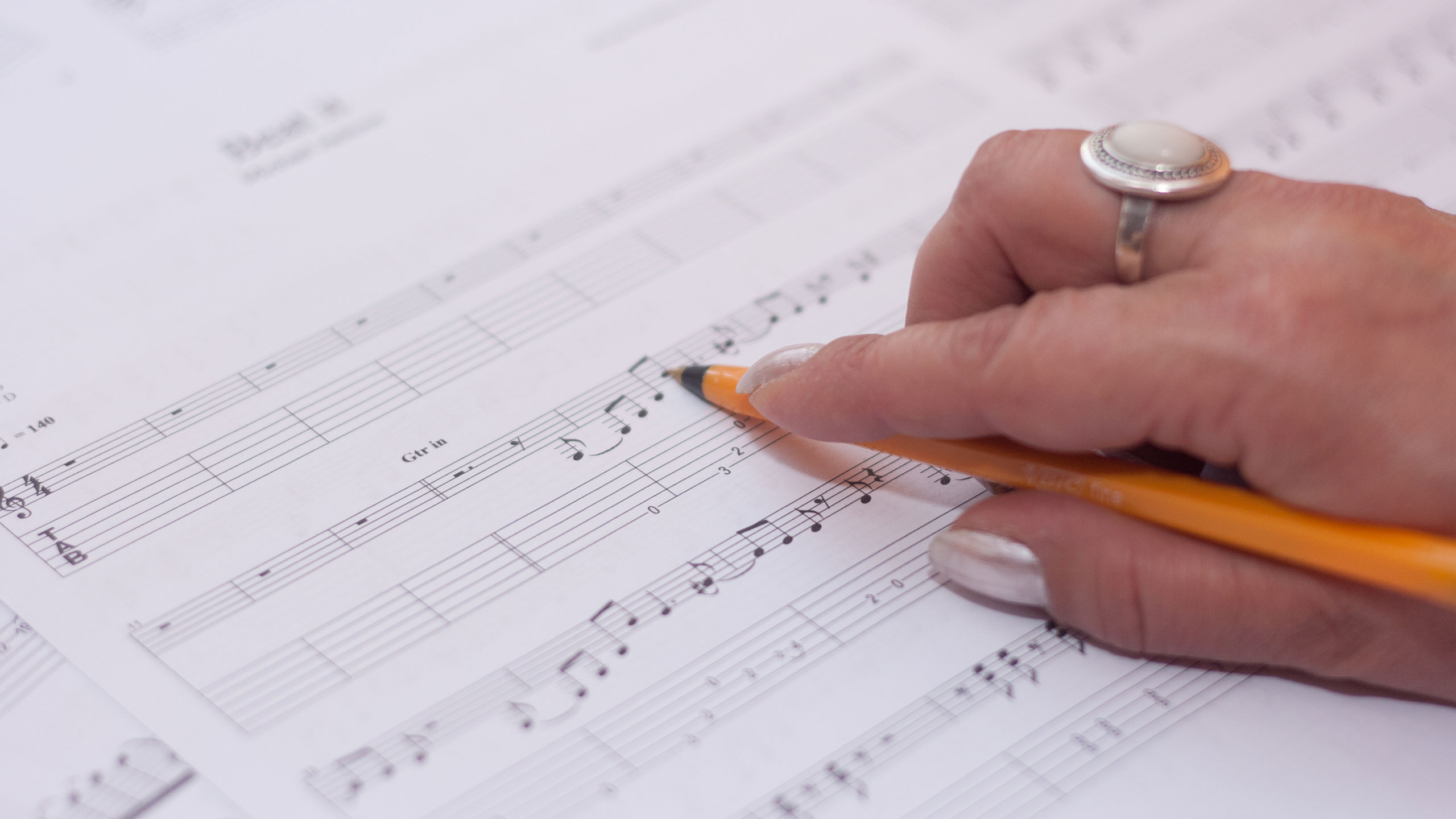  A hand writing music notation