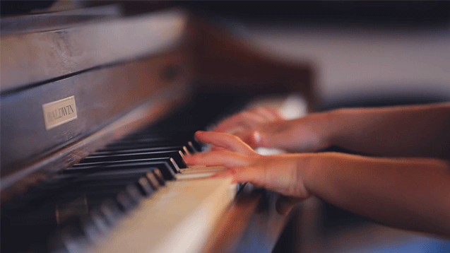 child on piano